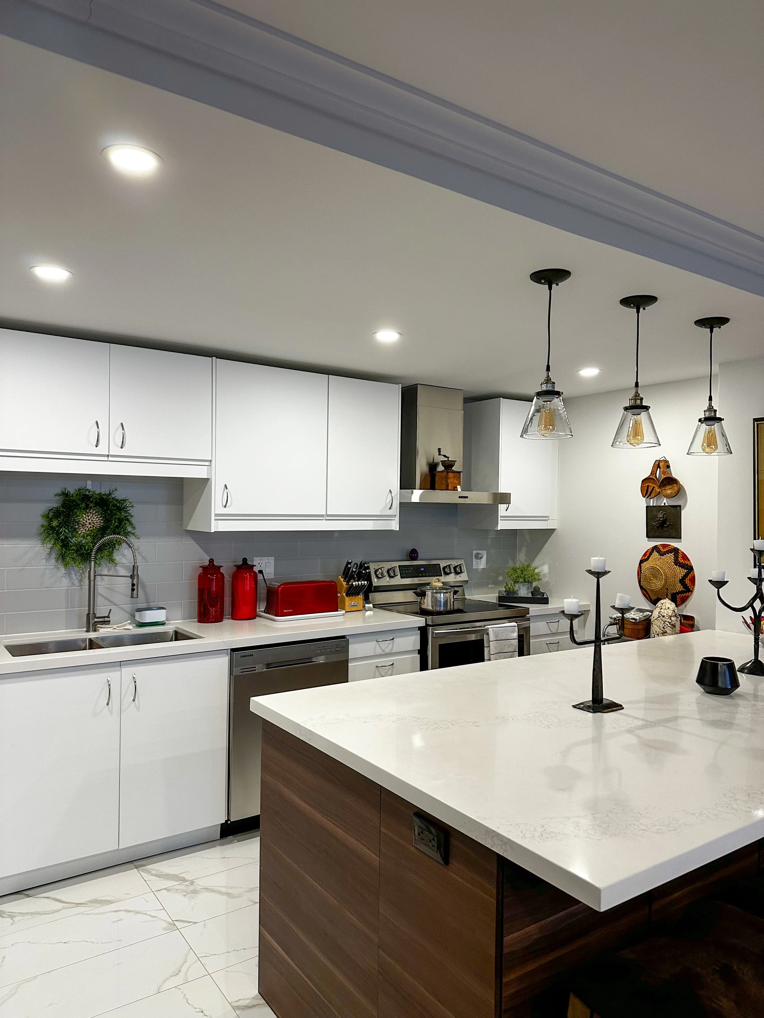White painted kitchen with crown mouldings and a brown island