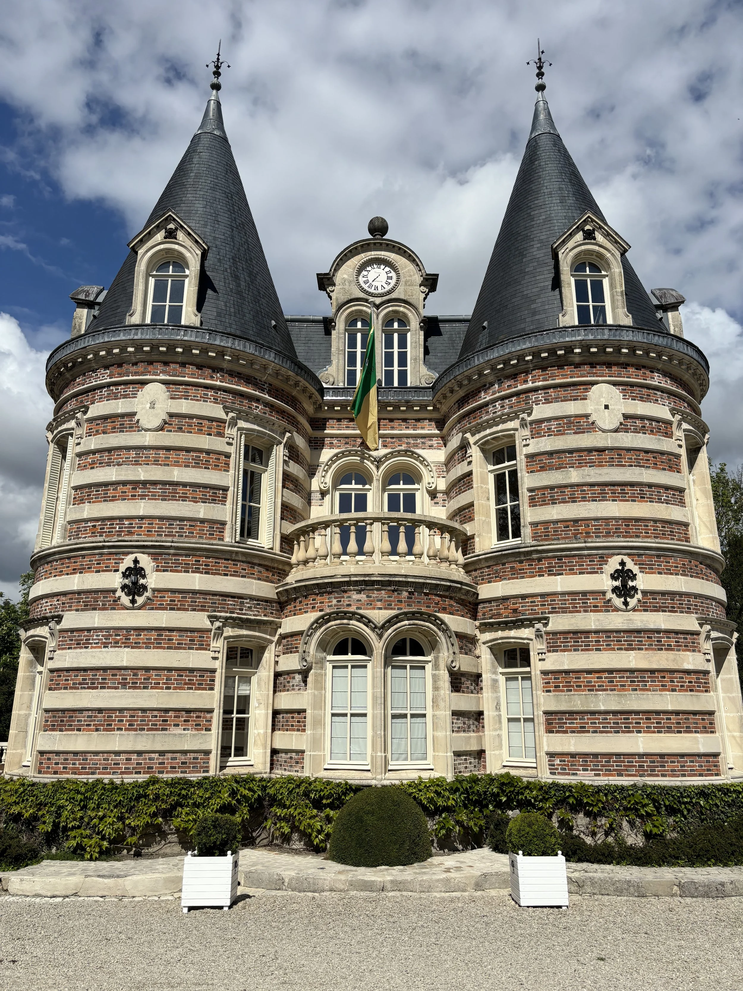 Château Comtesse Lafond with twin turrets and a central clock tower, in the Champagne region of France