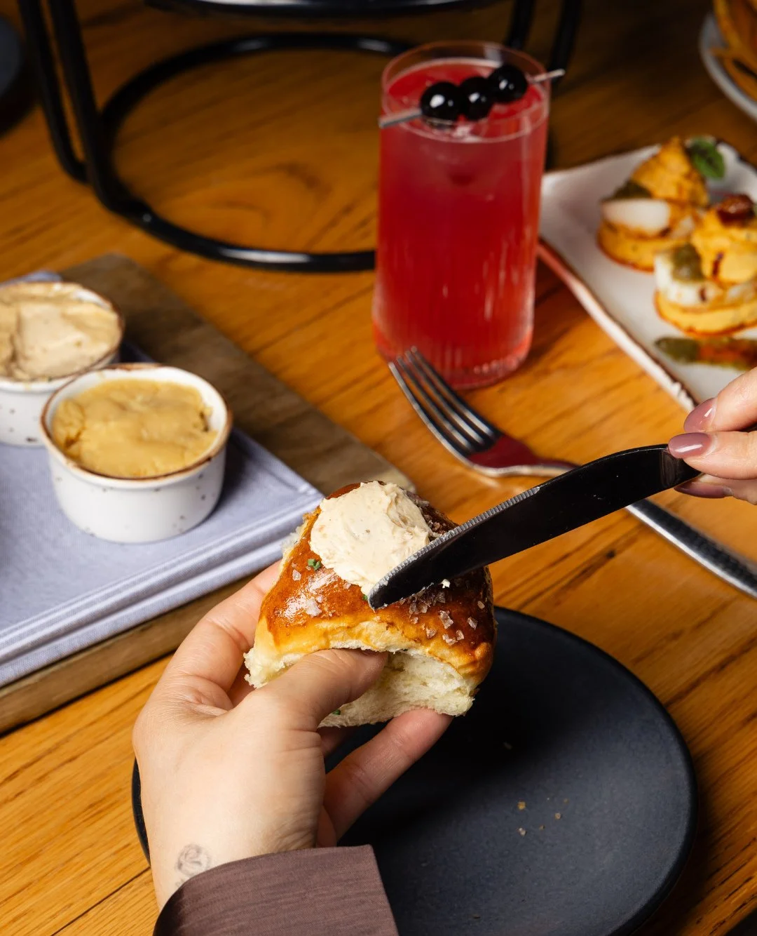 Pull up a chair and let's break bread together. ⁠
⁠
Our Parker House Rolls are baked fresh and accompanied by strawberry &amp; sorghum butters, topped with sea salt and chives. The perfect start to a shared meal with the ones you love.