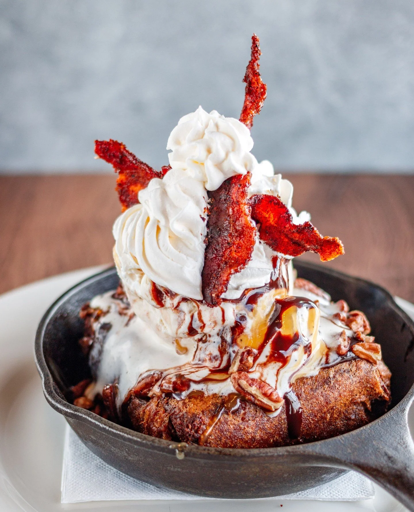Golden-fried brownie. Vanilla ice cream. Candied bacon on top. 🍨🥓 That&rsquo;s how we do National Dessert Day!⁠
⁠
#Pucketts #Nationaldessertday #friedbrownie #desserts