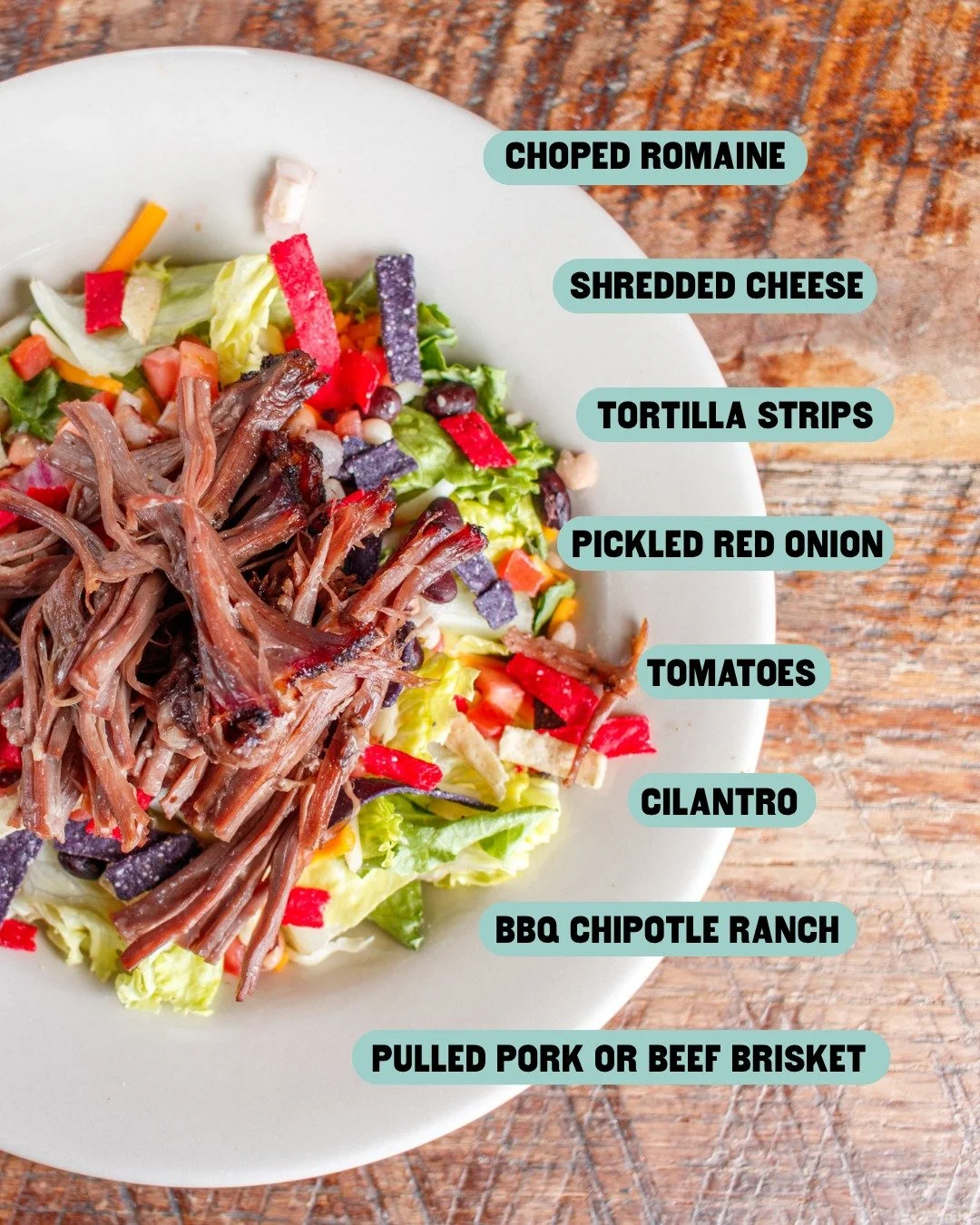 Who says salads have to be boring? 😉

Our BBQ Taco Salad is loaded with fresh toppings, crunchy tortilla strips, BBQ chipotle ranch and your choice of cherry wood-smoked pulled pork or beef brisket.