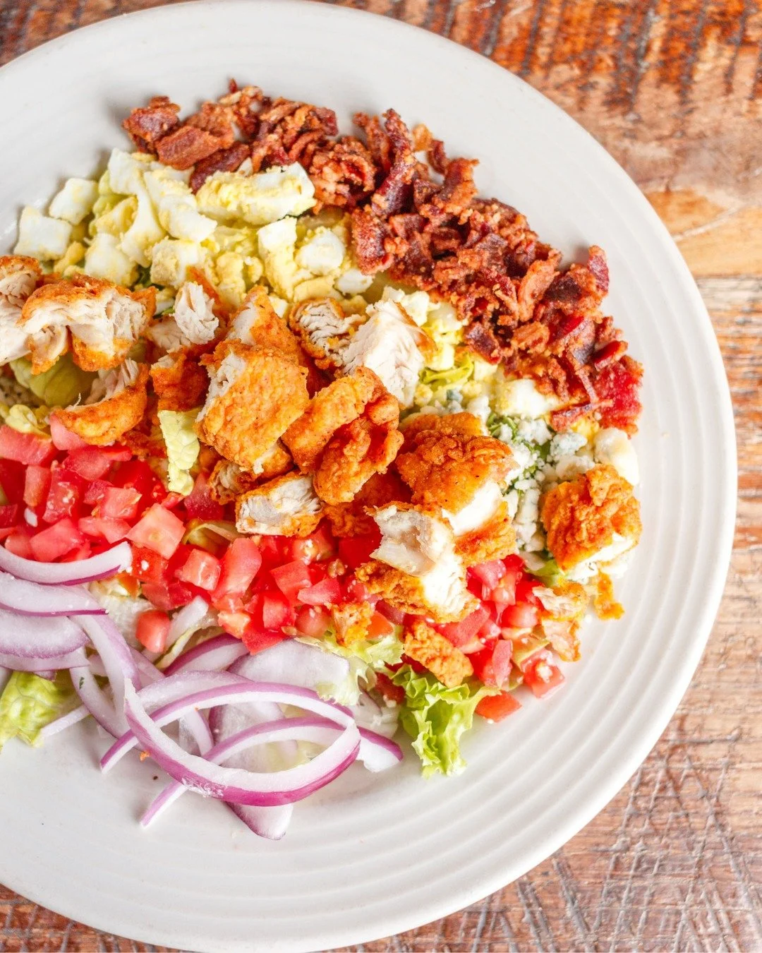 A little green, a little Southern comfort and a whole lot piled on top.

Our Country Cobb brings together crisp romaine, fried chicken, bacon, blue cheese, egg and all the fixings, finished with house-made buttermilk ranch. Just the thing for a lunch