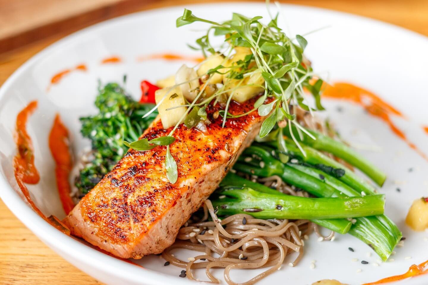 🍍✨Dive into a flavor explosion with our Sobayaki Salmon at Scout&rsquo;s Pub! 🥢🐟 Indulge in perfectly blackened salmon served with hearty buckwheat noodles, charred broccolini, and topped with our irresistible bang bang sauce and pineapple-chili p