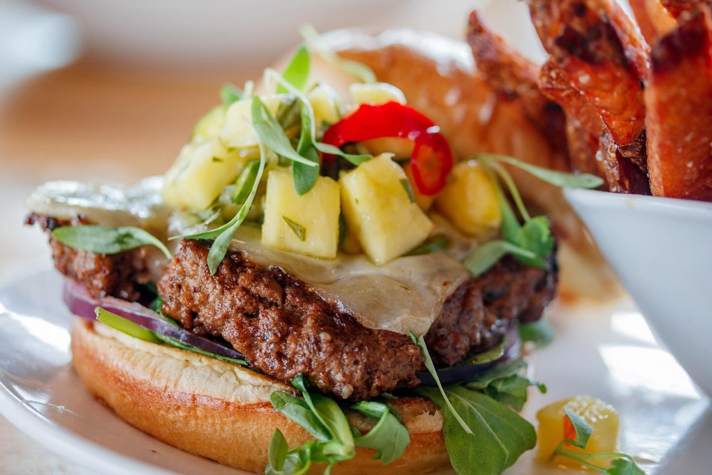 🍔🌟 Ready to level up your burger game? Meet our KBQ Burger from Scout&rsquo;s Pub! 🤤🔥 ⁣
⁣⁣
⁣Stacked high with all the good stuff: Korean BBQ-infused turkey patty, tangy pineapple-chile salsa, melty white cheddar, fresh arugula, zesty red onions, 