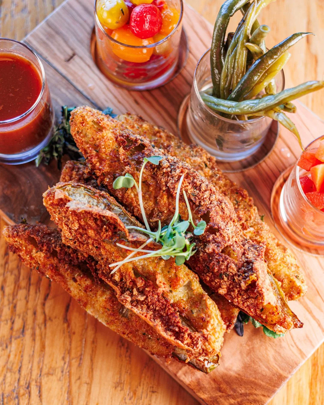 Send this to the friend who always orders the fried pickles.🥒⁠
The Southern Pickle Flight stacks the table with fried pickle spears, spicy green beans, dilly carrots, ranch, and Bloody Mary gazpacho.