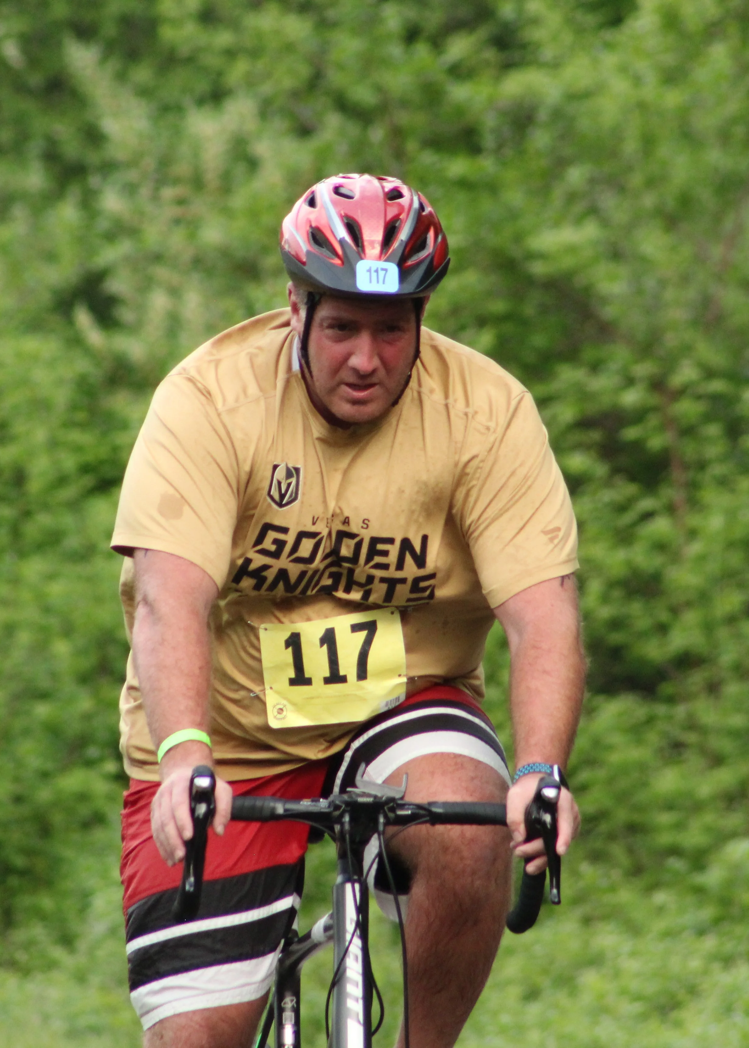 An athlete climbing on the bike