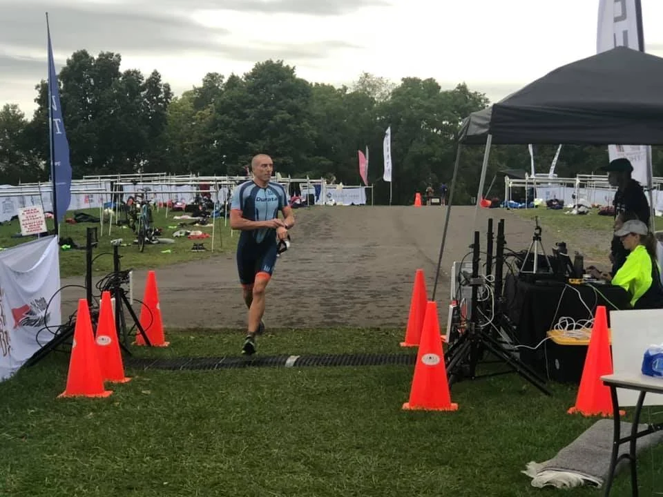 An athlete running through the timing chute