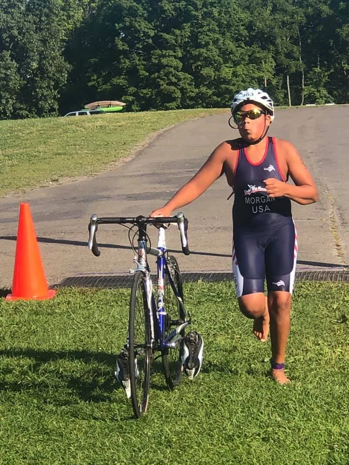 An athlete entering transition after dismounting the bike, getting ready for the run
