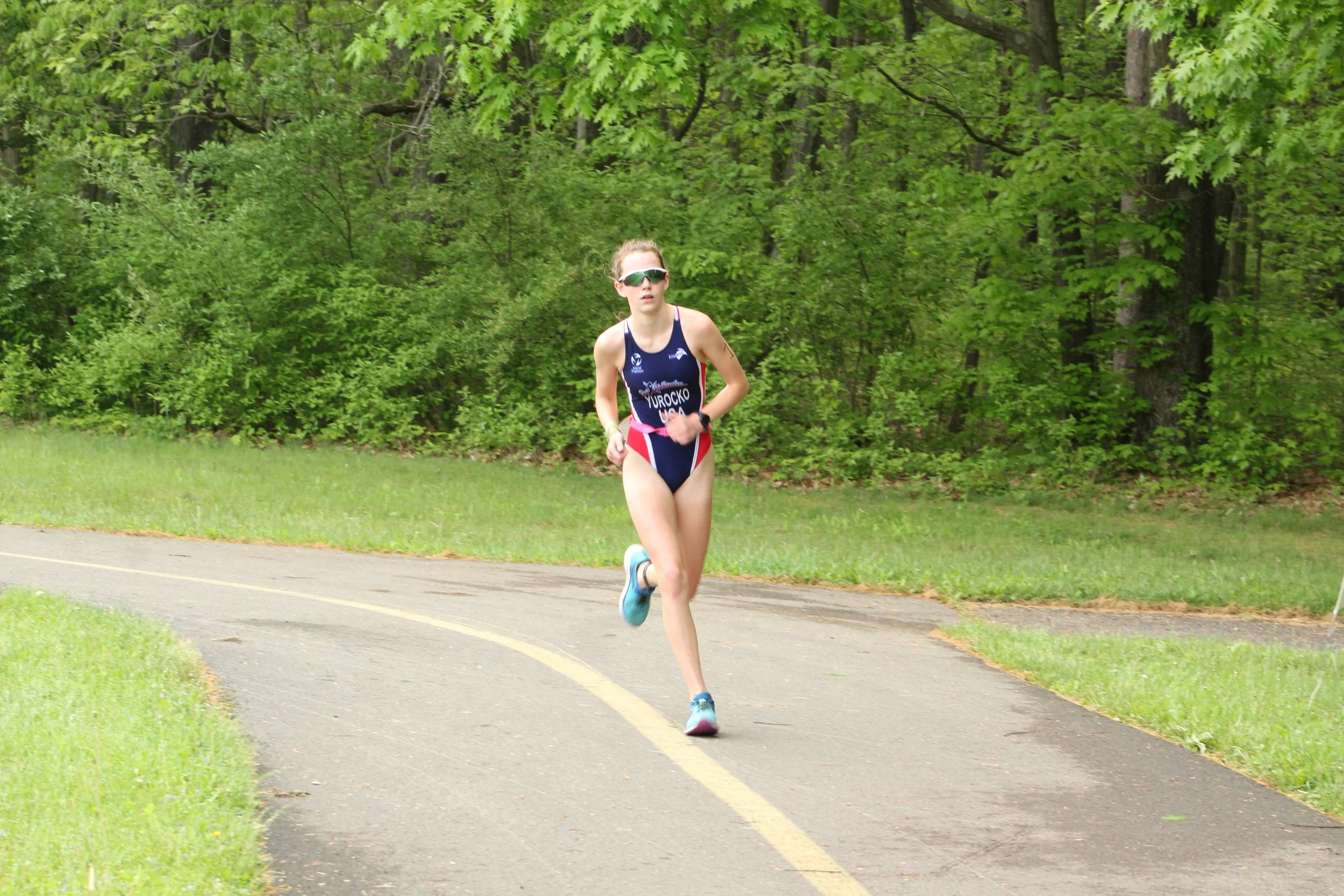 An athlete running the paved path at Moraine State Park