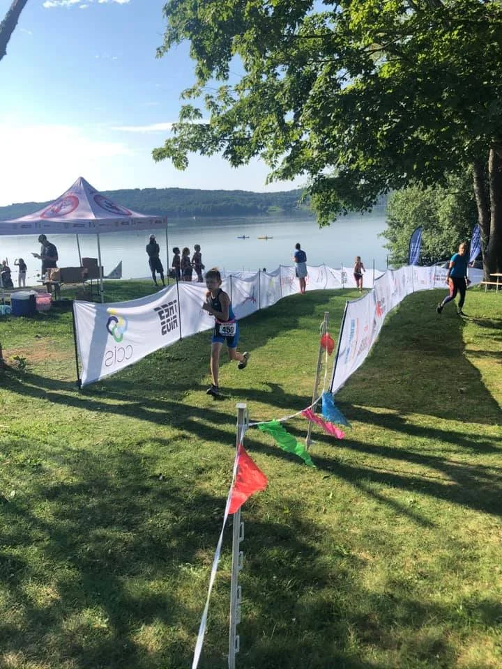 A youth athlete coming through the transition chute to the first transition, before the bike