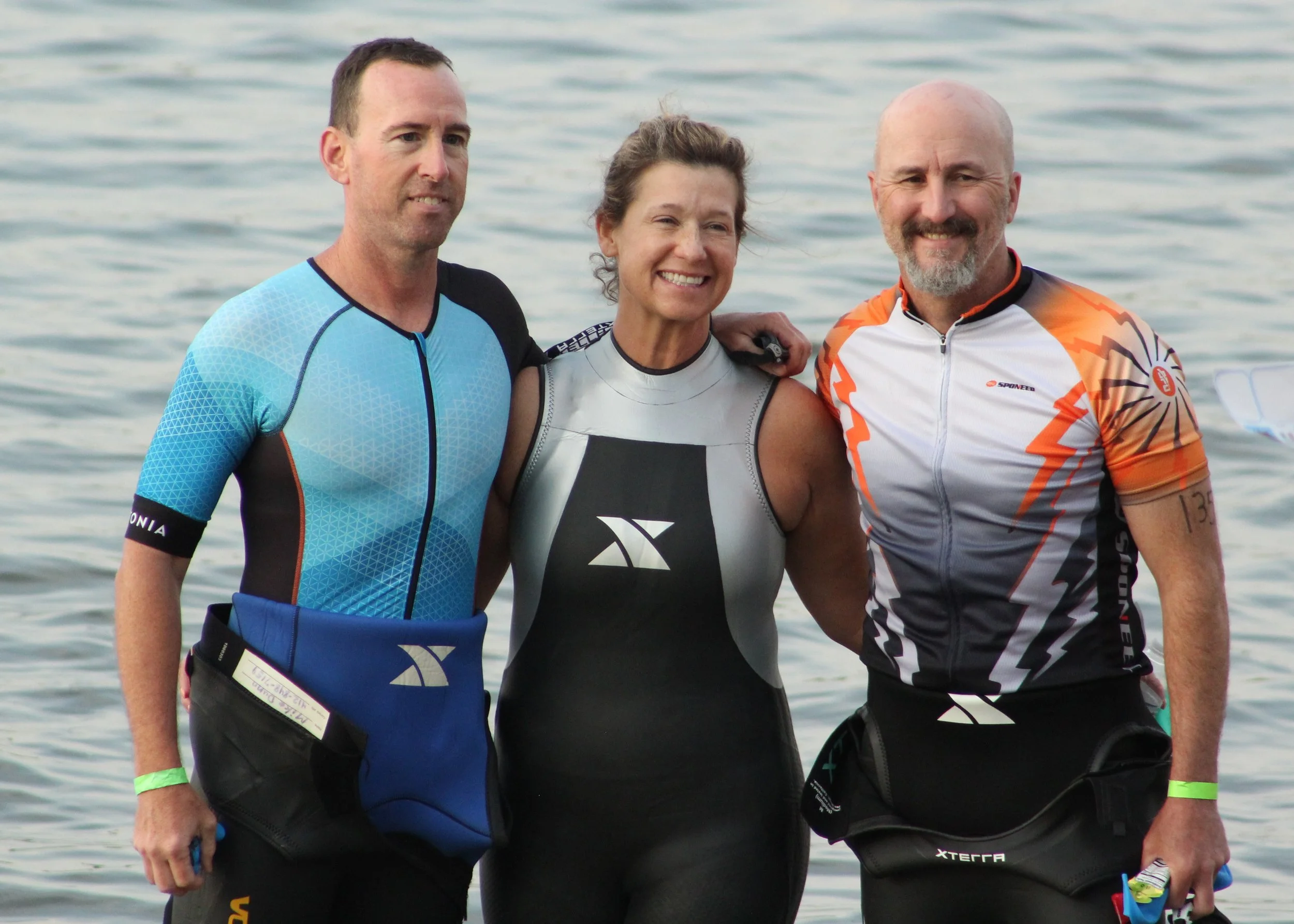 Three athletes standing together before a race