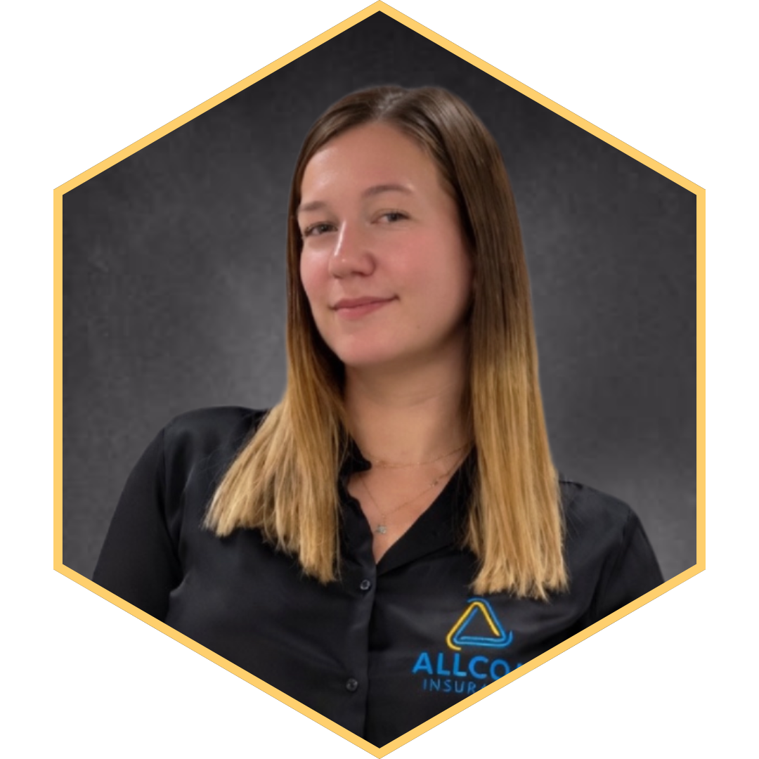 A young woman with long, straight, brown hair, wearing a black shirt with the Allco Insurance logo, standing against a dark gray background, smiling slightly.