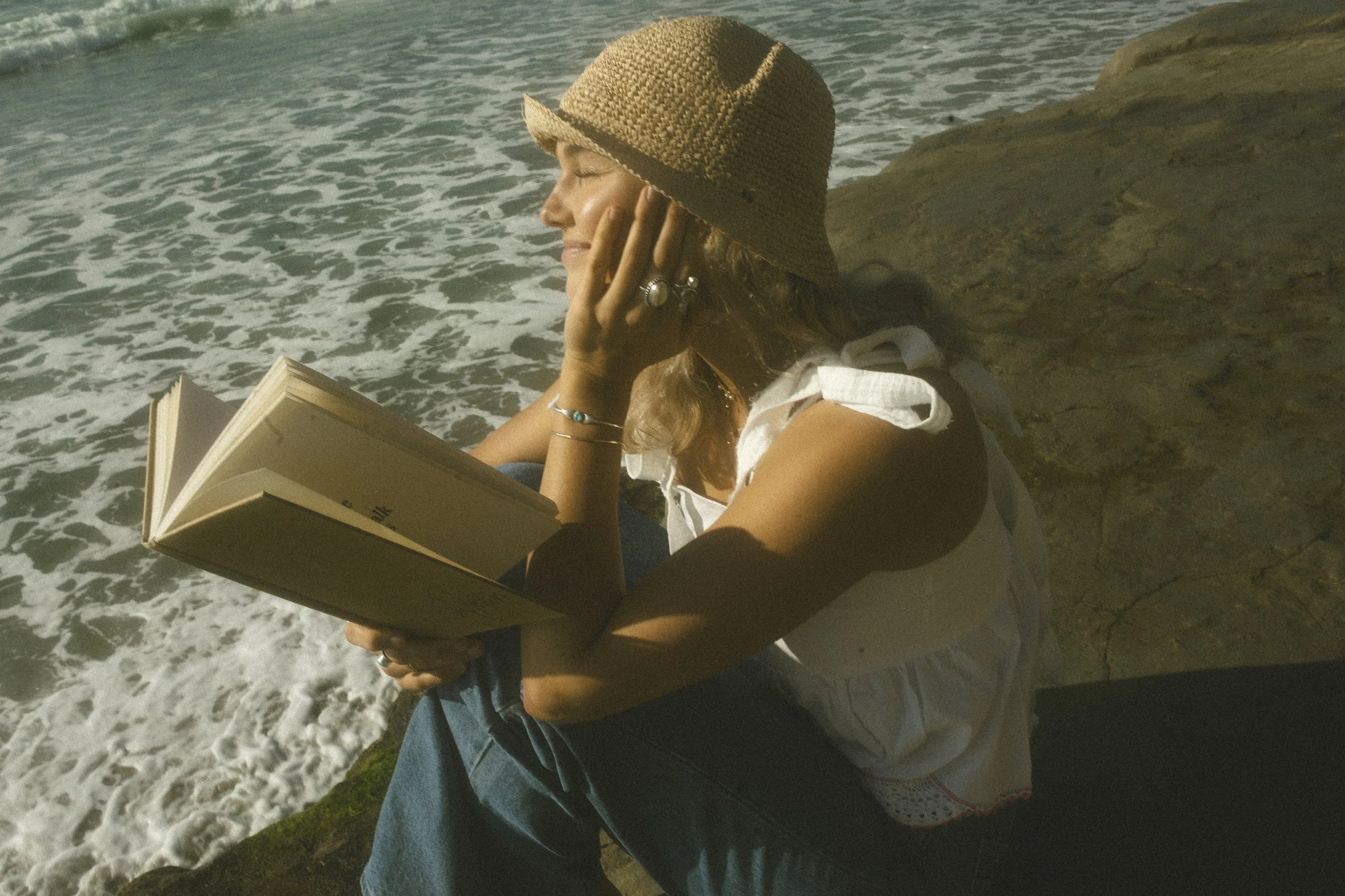 reading a book by the ocean