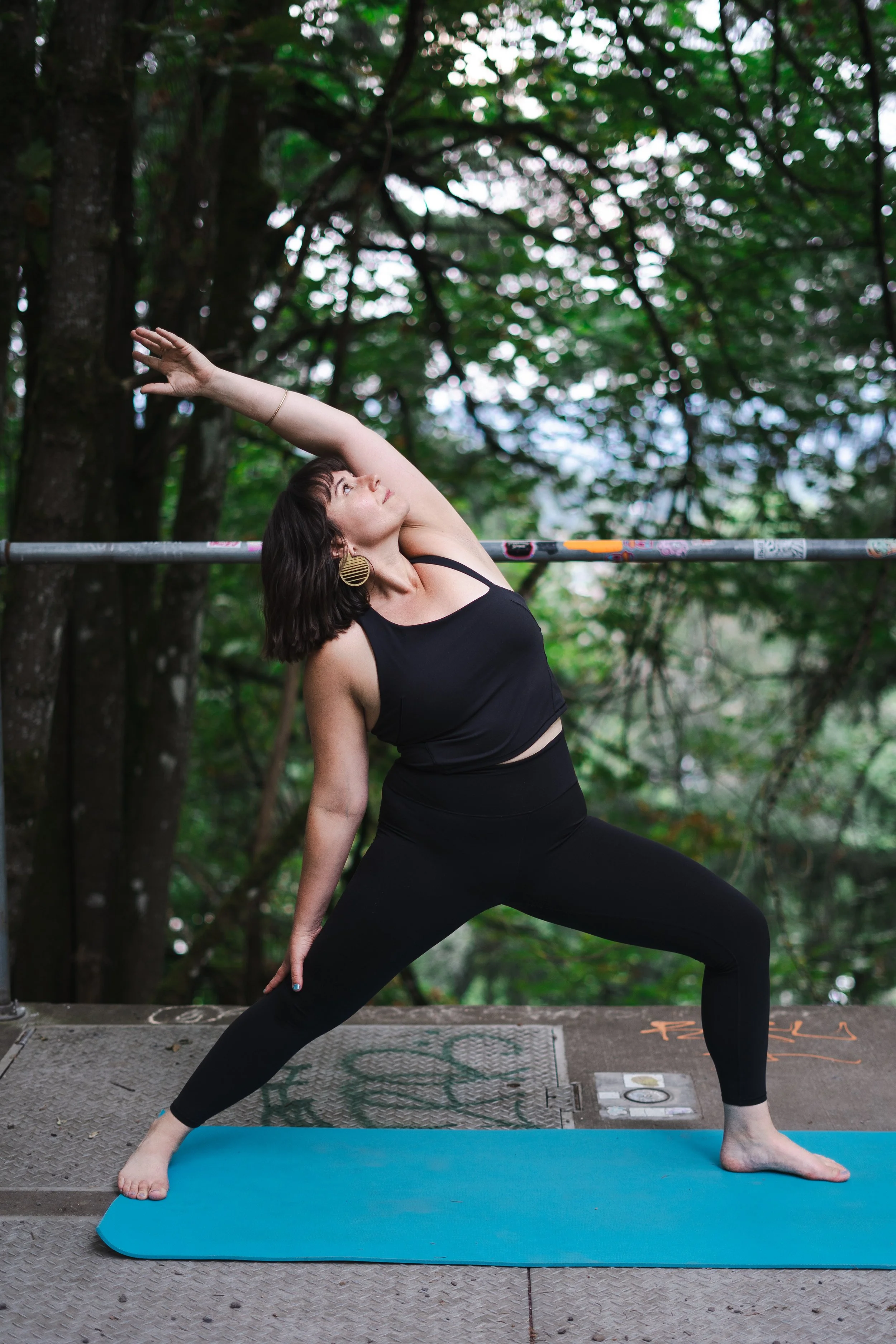 Yoga instructor leading all-levels outdoor yoga class in Portland