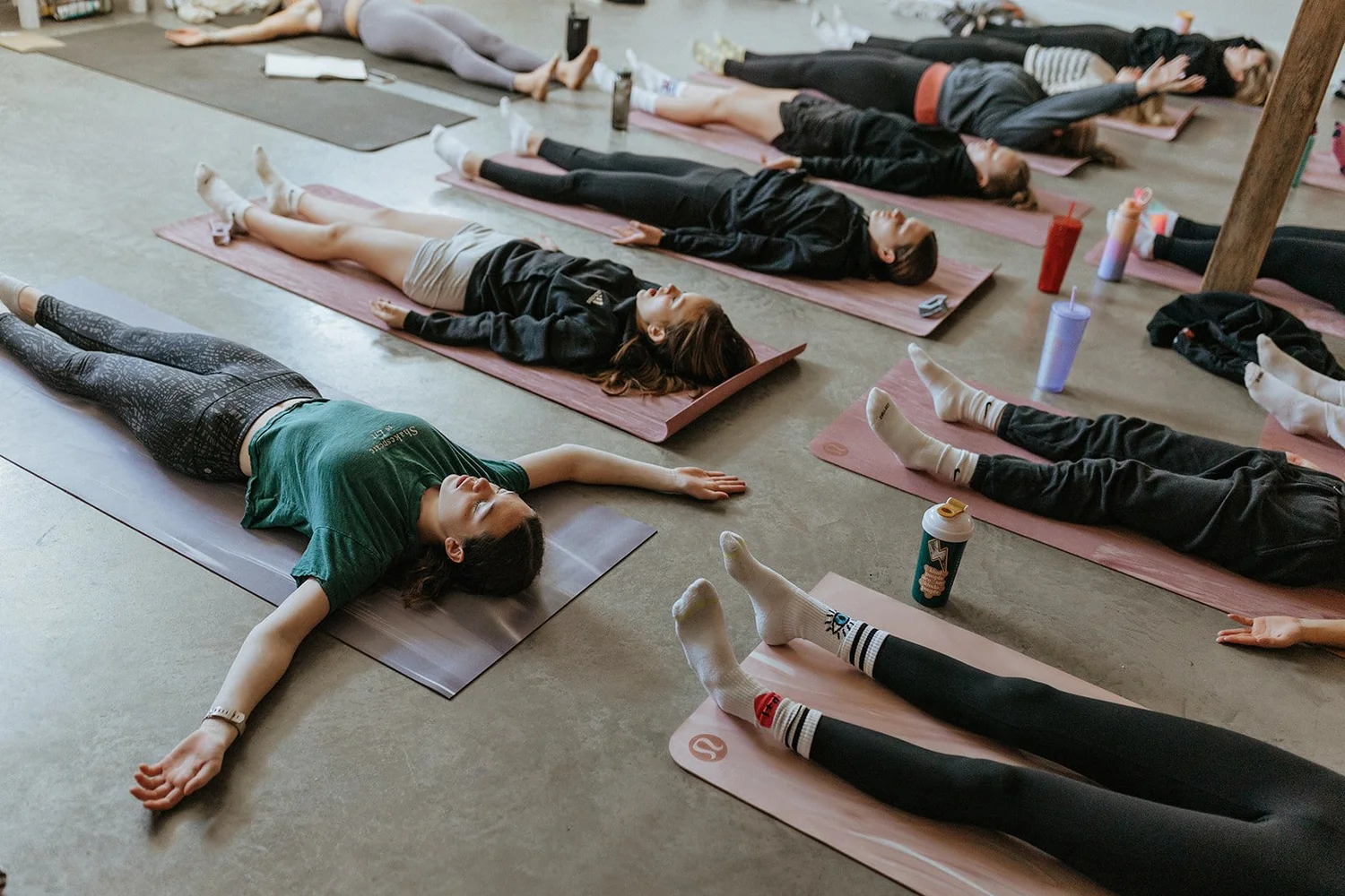 Girls resting on mats at the end of a session