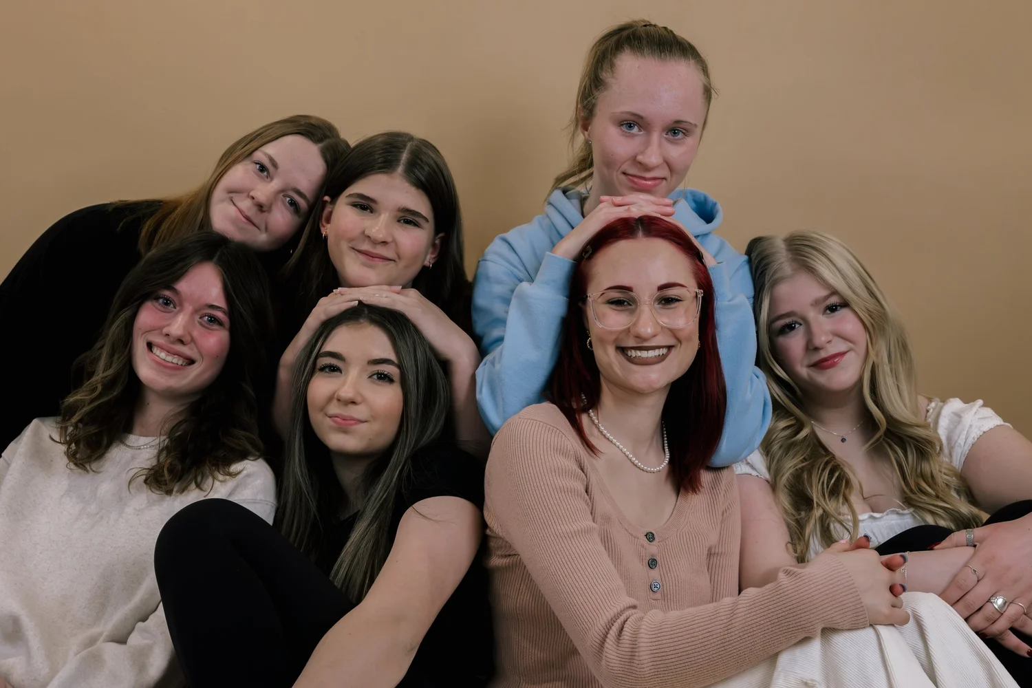 A group of teen girls together, smiling