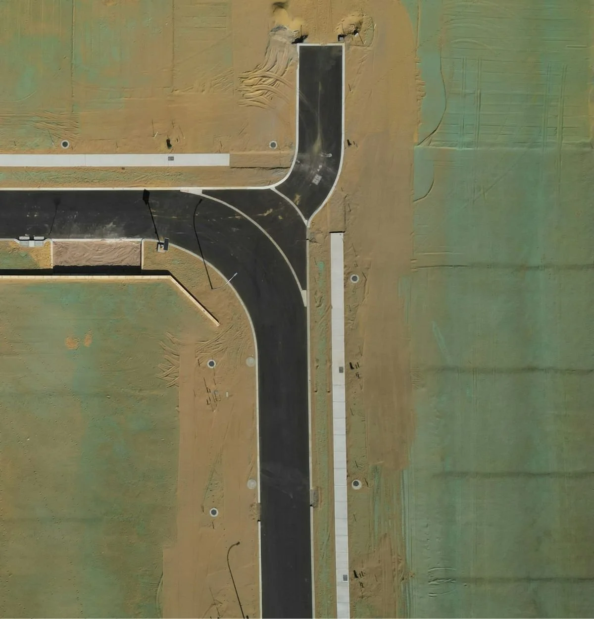 Aerial view of a suburban Arizona development beside open desert land