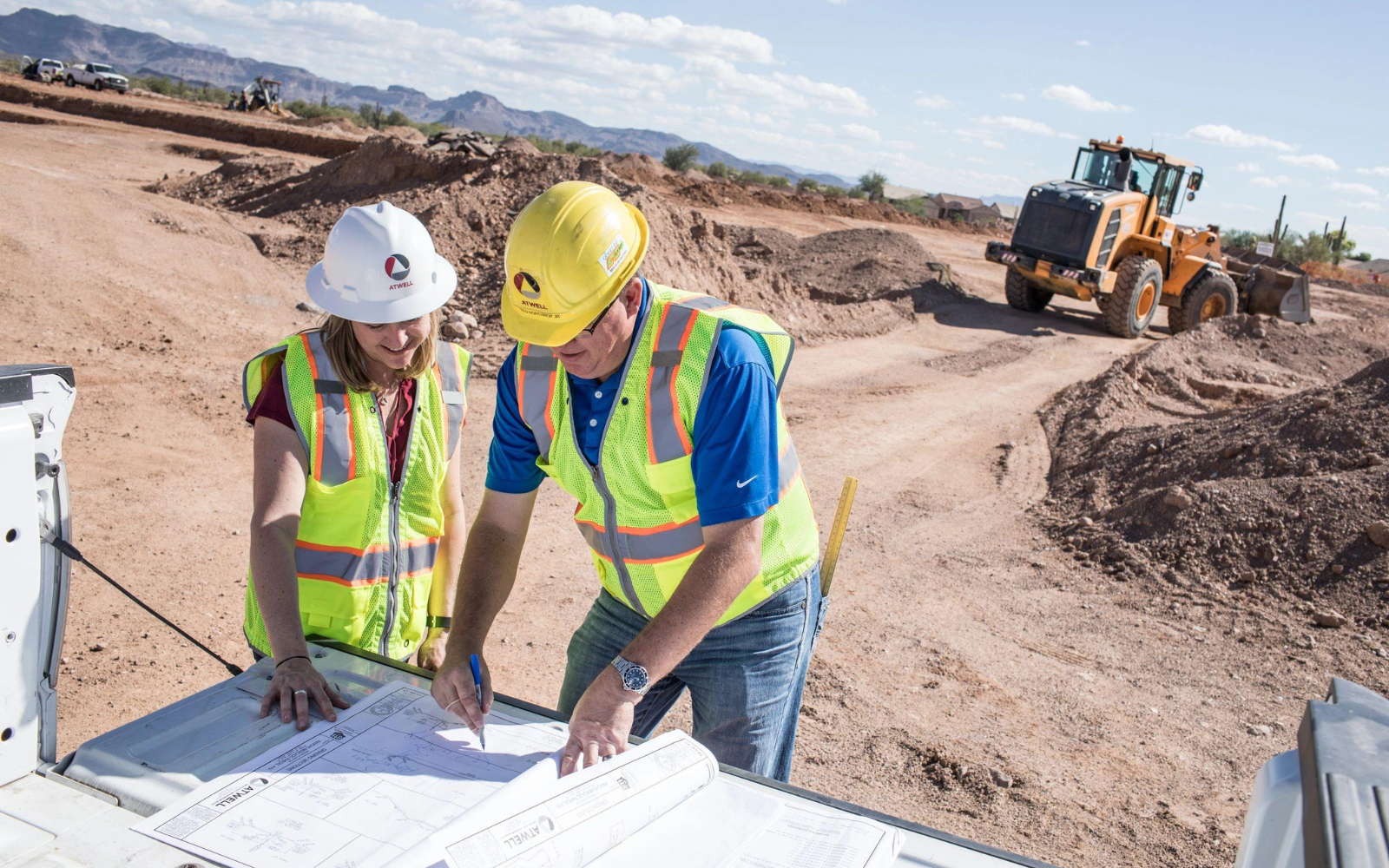 Engineers reviewing site plans at an Arizona development site