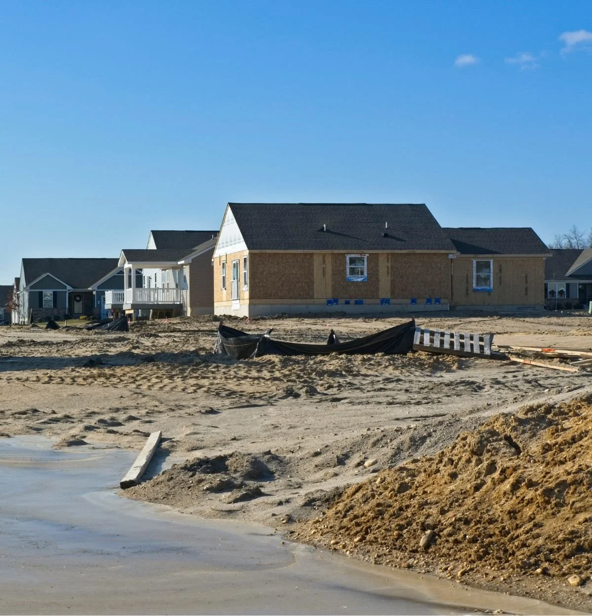 Residential construction site with new homes and open ground for site planning