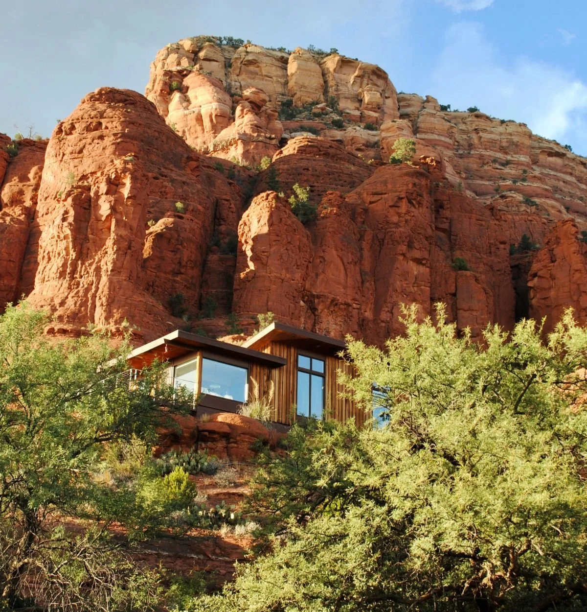 Arizona home on a desert property beneath red rock cliffs