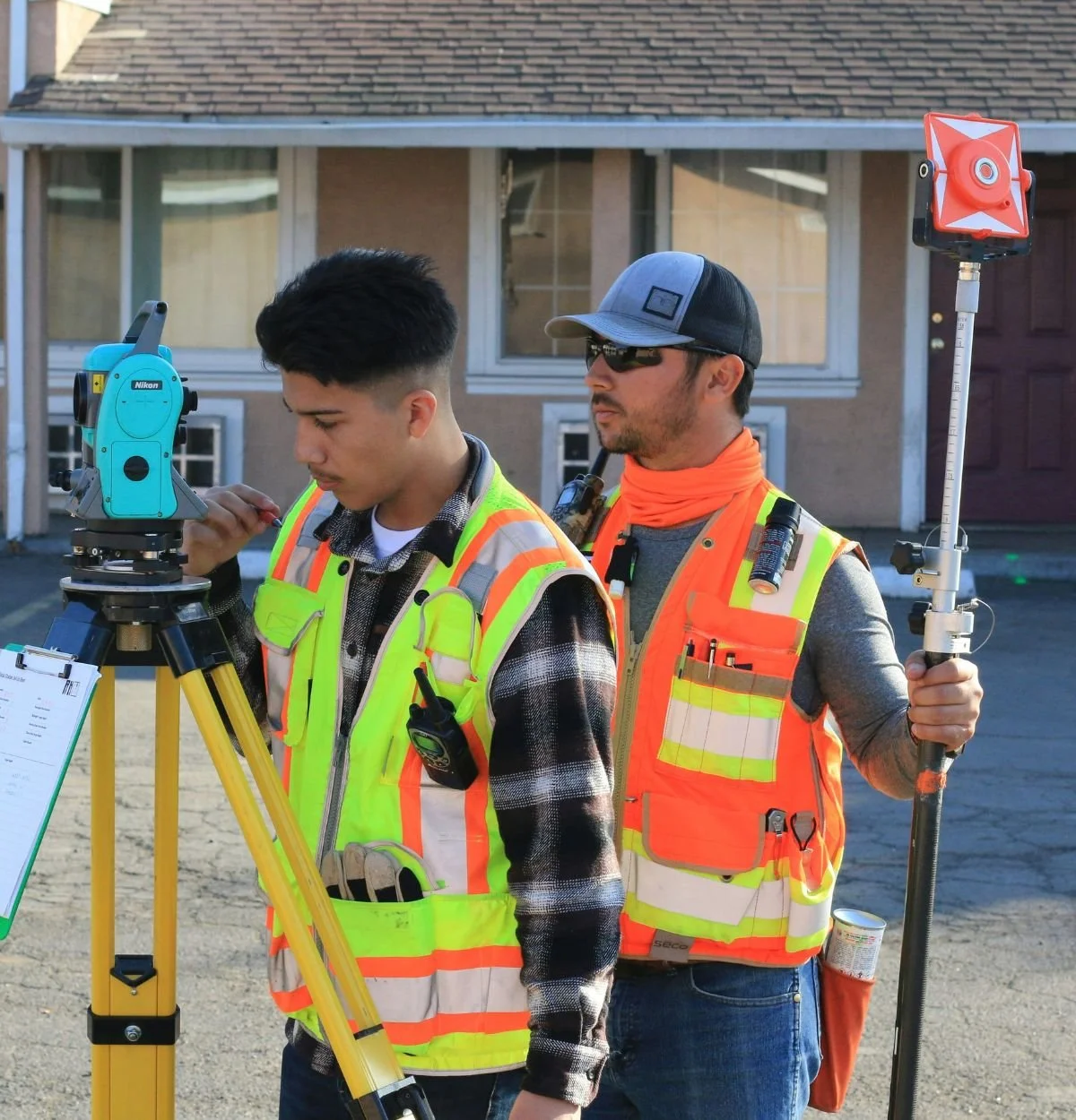 Surveying professionals evaluating a residential property for site planning in Arizona