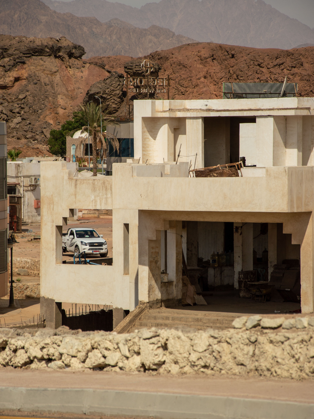 Modern home on a dry property with rugged mountains in the background