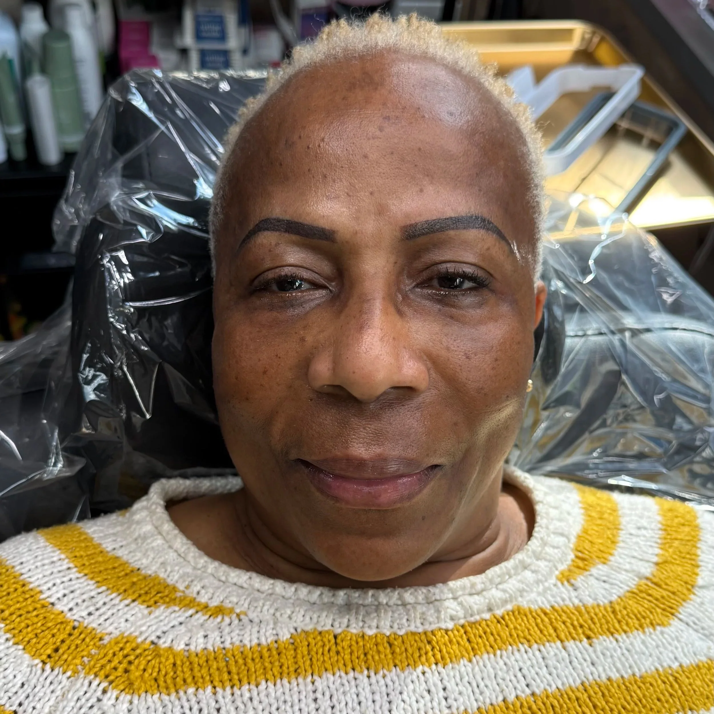 Close-up of a person's eye area showing before and after Permanent Makeup. Powder Brows. Nano strokes. Fairfax permanent makeup artist.