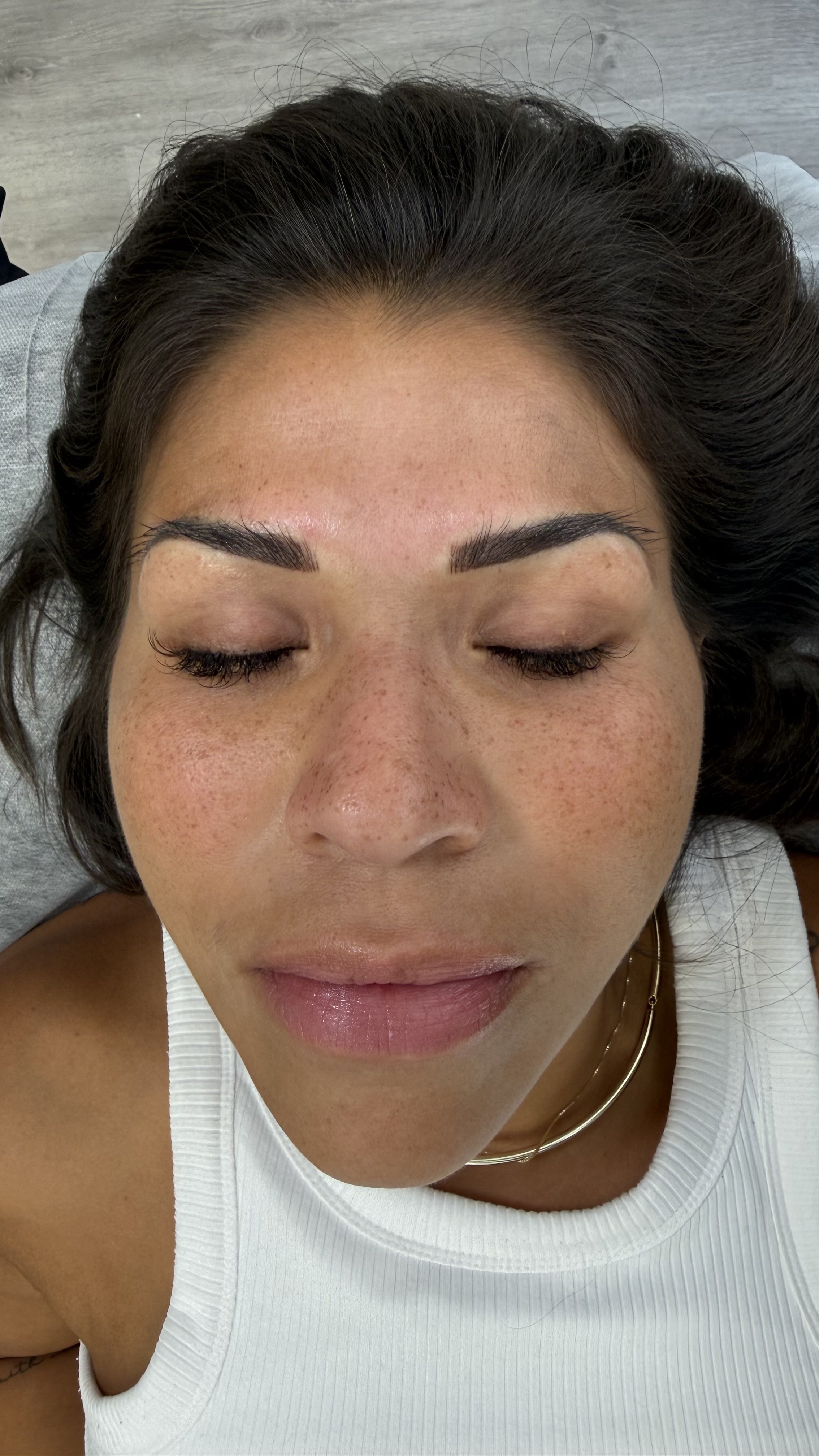 Close-up of a person's eye area showing before and after Permanent Makeup. Powder Brows. Nano strokes. Fairfax permanent makeup artist. Lip Blushing.