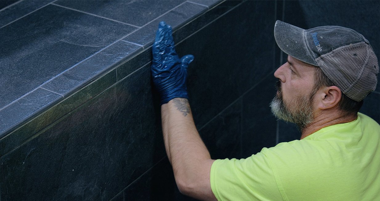 Close-up of hand-tiled finish inside a luxury precast plunge pool.