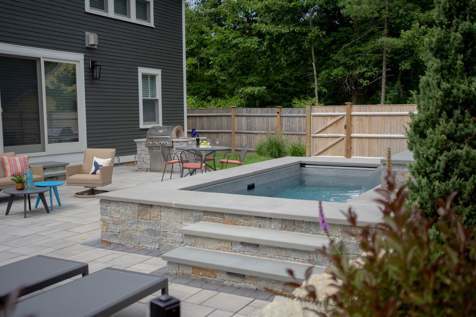 A RAISED COCKTAIL POOL WITH STEPS TO ENTER AT EASE IN NEWBURYPORT, MA.  