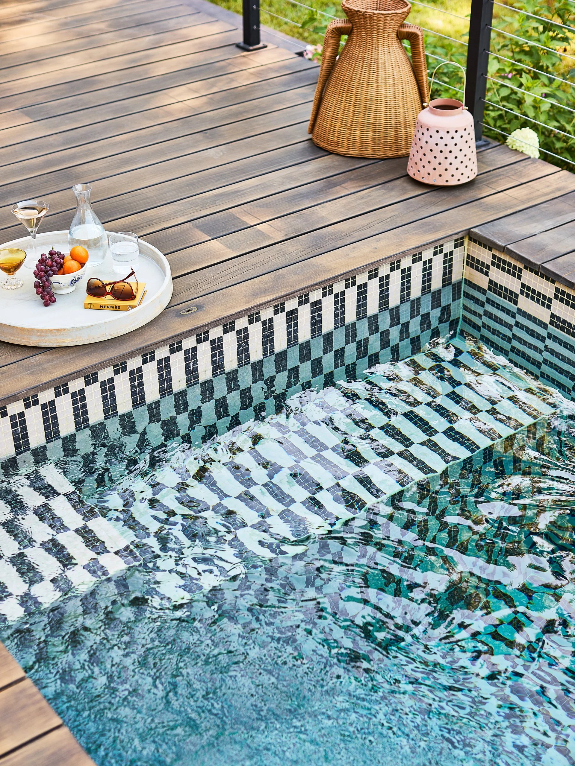 THIS PRECAST CONCRETE PLUNGE POOL FEATURES A HAND-TILED CUSTOM MOSAIC INTERIOR, PROVING PREMADE POOLS CAN DELIVER HIGH-END, BESPOKE DESIGN.