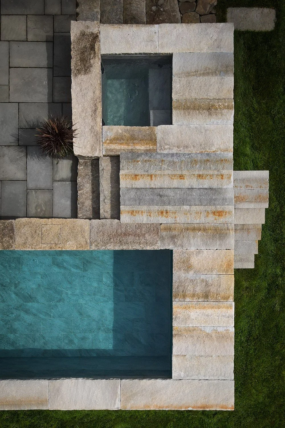 Overhead view of an artisanal repurposed stone plunge pool and cold plunge, showcasing compact, high-end outdoor design for a luxury, wellness-focused guest experience.