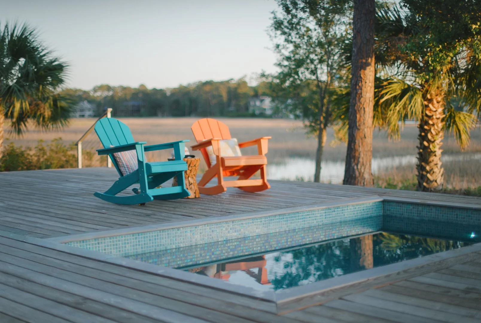 A QUIET POOLSIDE MOMENT BESIDE A FULLY CUSTOM MOSAIC-TILED SOAKE POOL IN HILTON HEAD, SOUTH CAROLINA.
