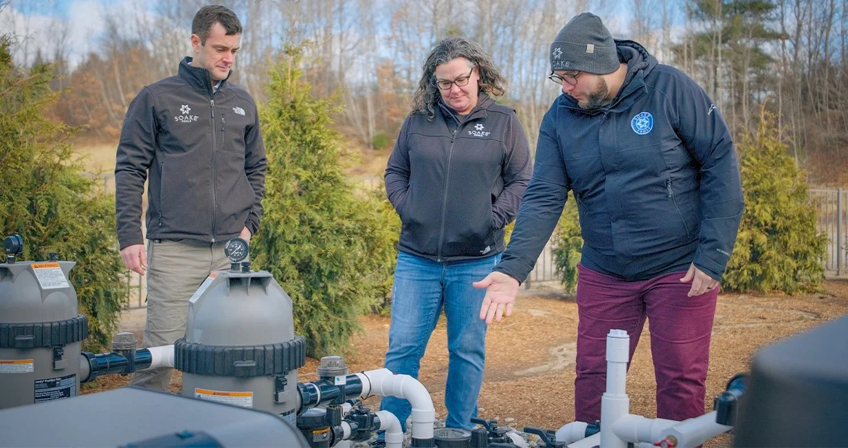 Plunge pool technical team reviewing pool equipment and installation setup.