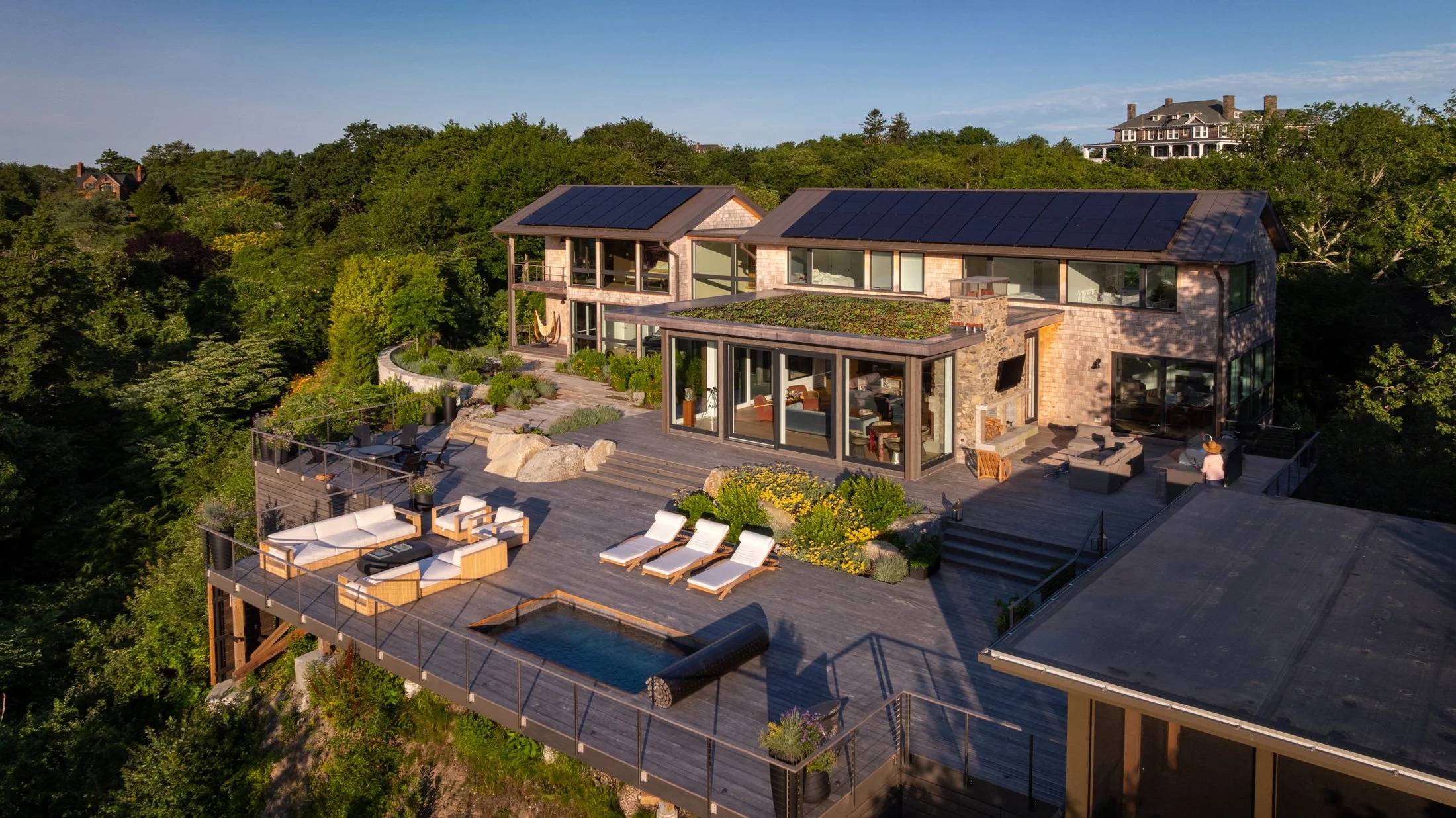 MODERN COASTAL RETREAT WITH A SOAKE POOLS PRIVATE PLUNGE POOL ANCHORING THIS EXPANSIVE ROOFTOP ENTERTAINING DECK.