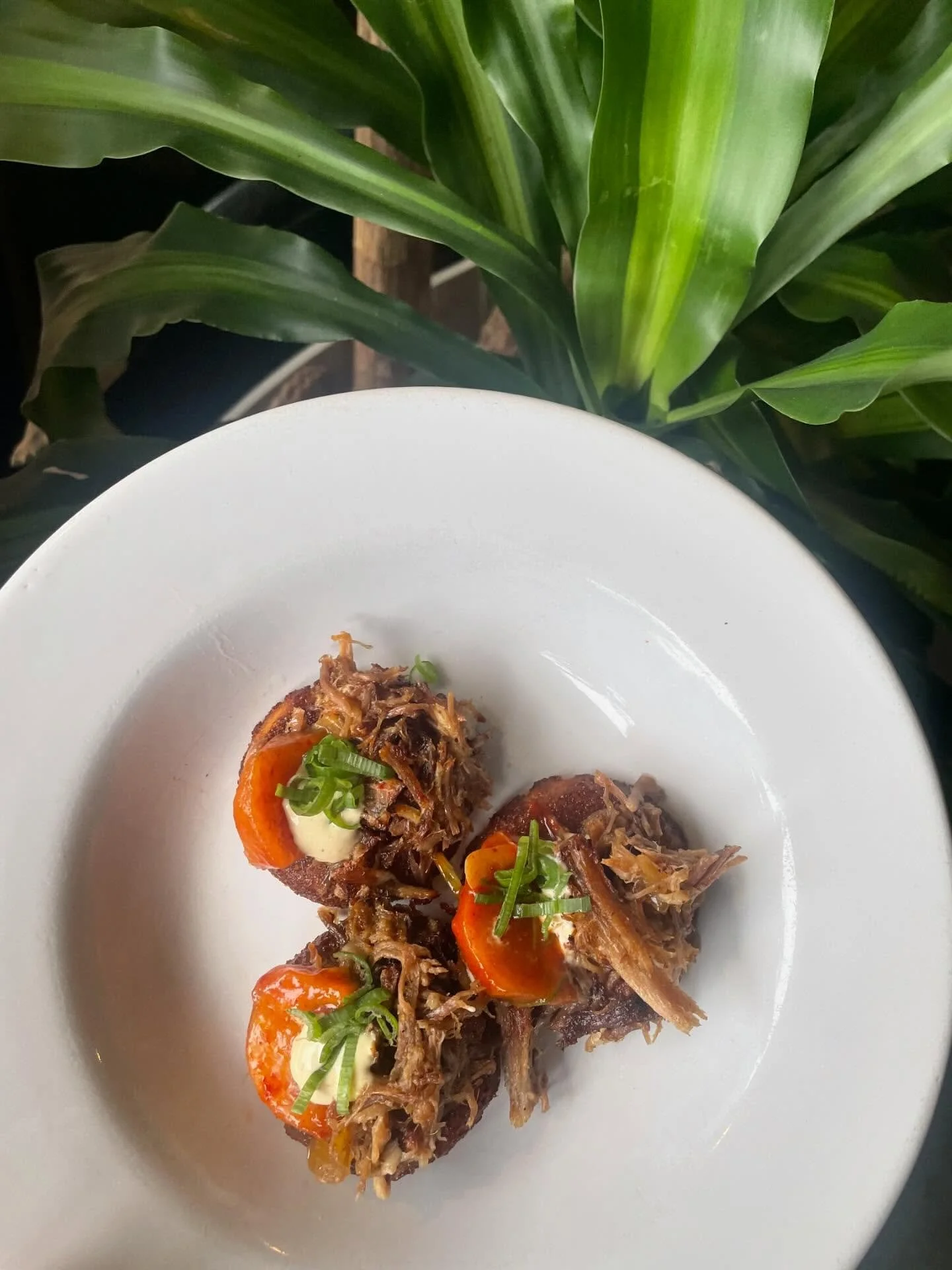 Pulled pork bites on special this weekend! Laughing Stock pork, persimmon kimchi, fresh persimmon &amp; red eye aioli on silver dollar cornbread 💥