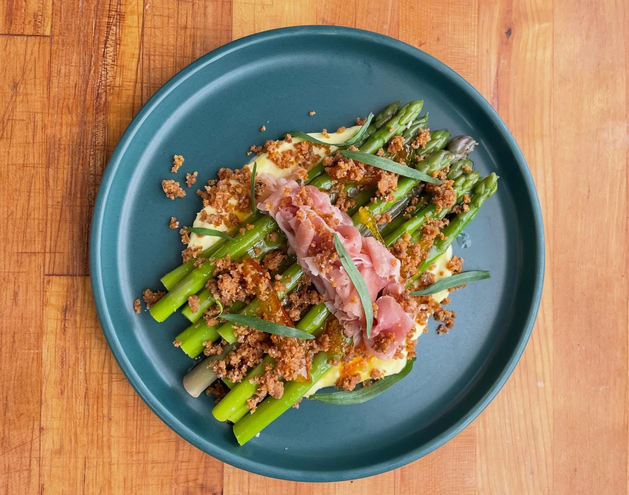 One of our super seasonal spring menu items: @circle_h_organic_farm asparagus, @bentonsbacon country ham, Parm pudding, orange marmalade, tarragon, &amp; cracklin&rsquo; crumbs.