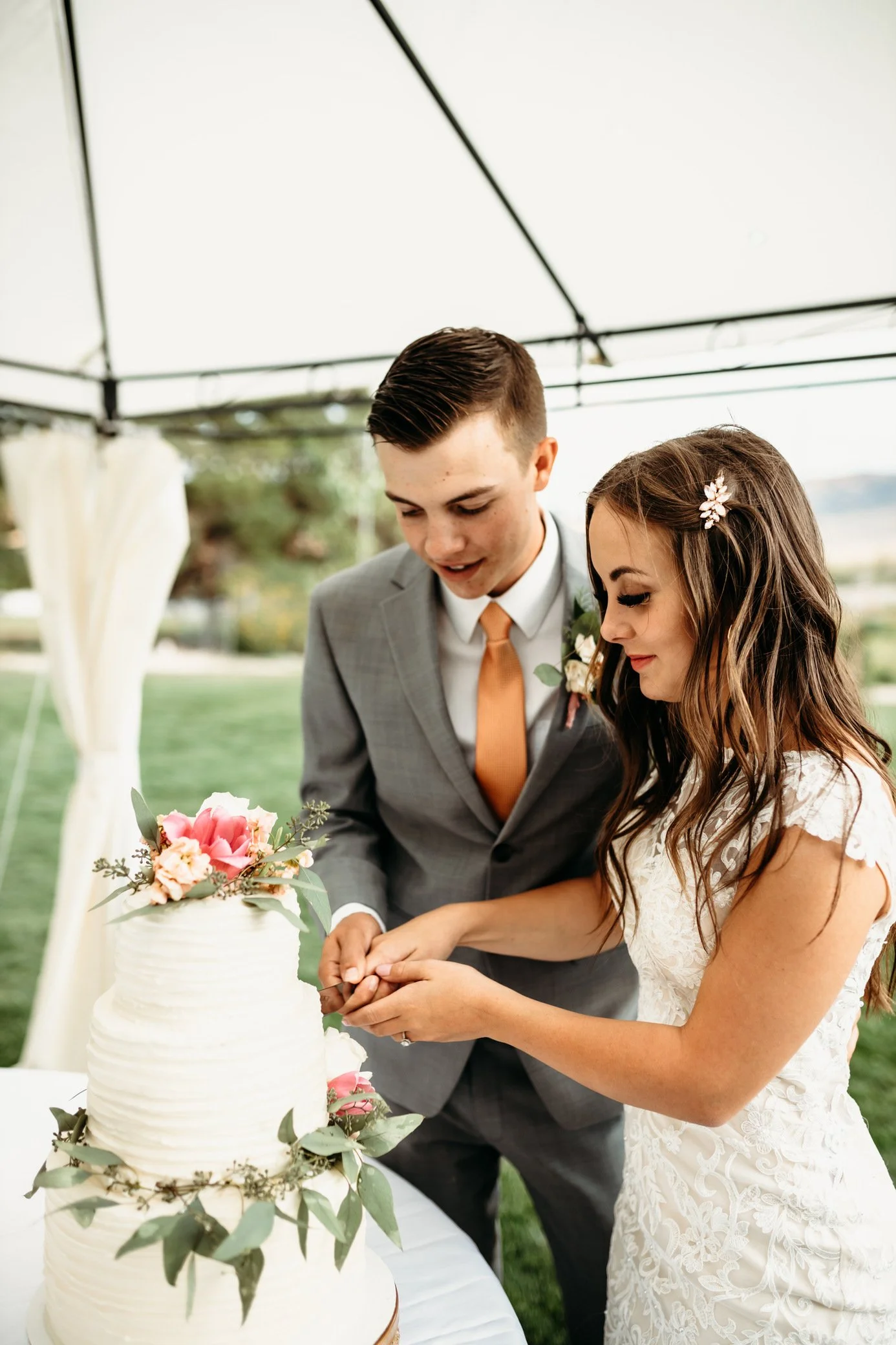 bride and groom cutting wedding cake