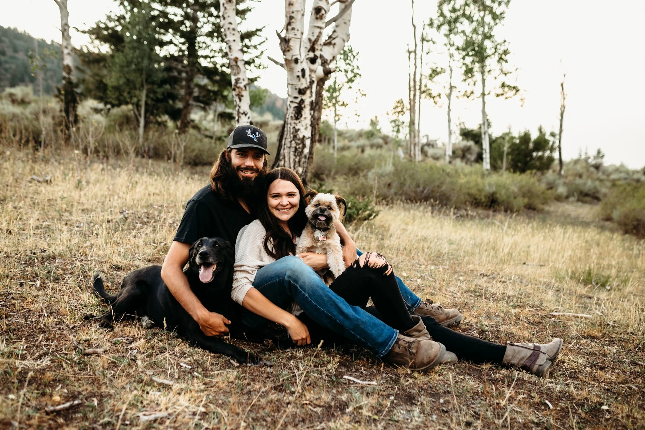couple with dogs in mountains