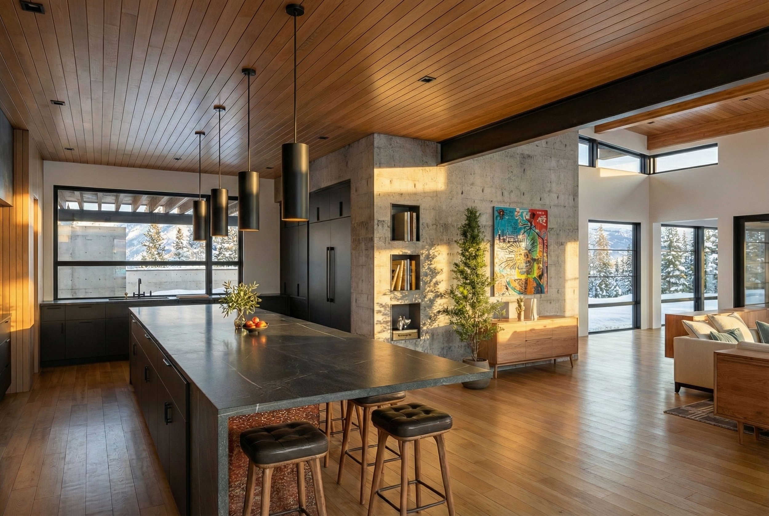 Open-concept living space with a kitchen, wooden ceiling, natural light, and large windows showing snowy trees outside