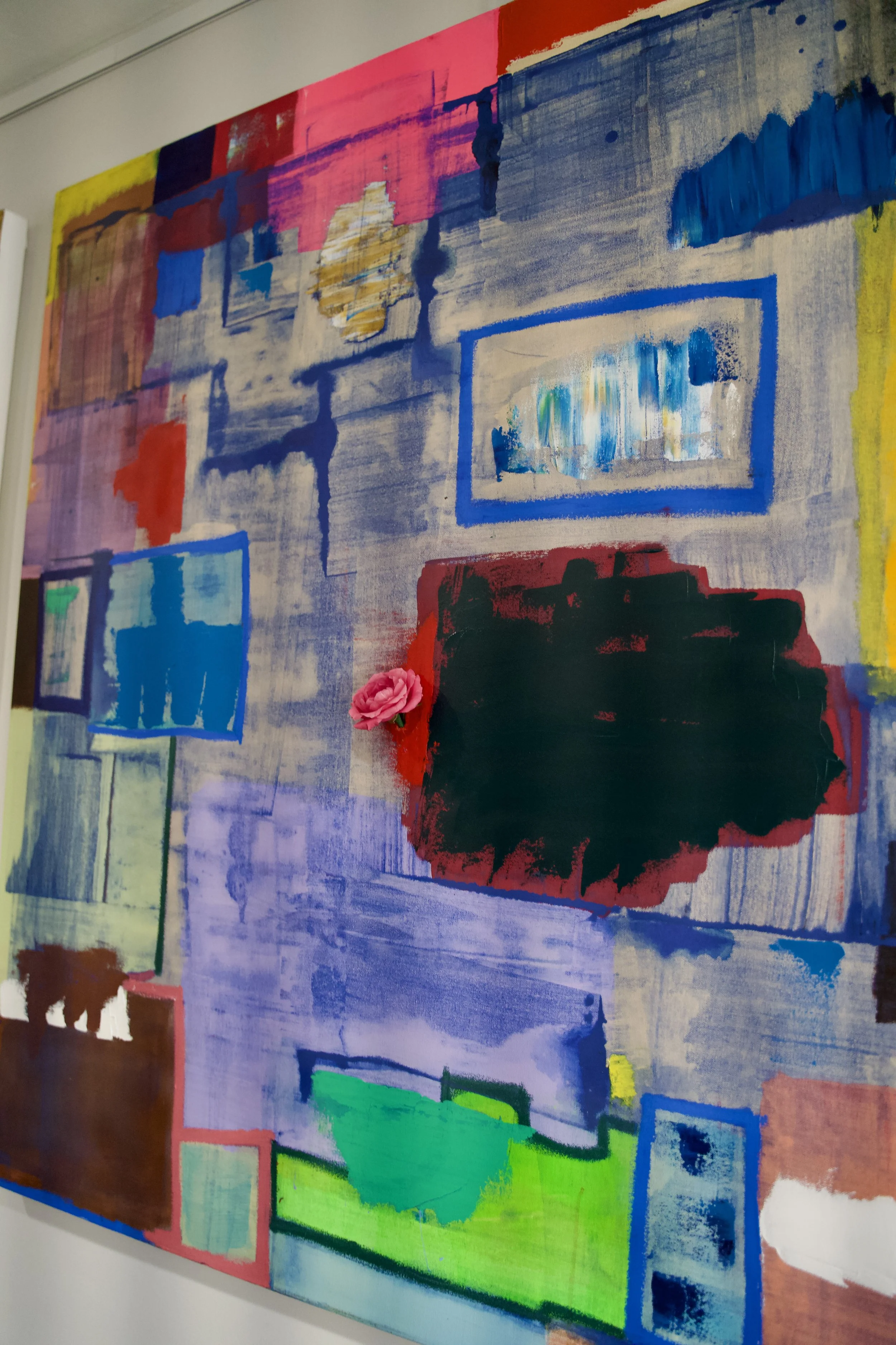 Abstract mixed-media artwork with various colorful rectangles, brush strokes, and textures, including a pink rose attached to the lower middle area.