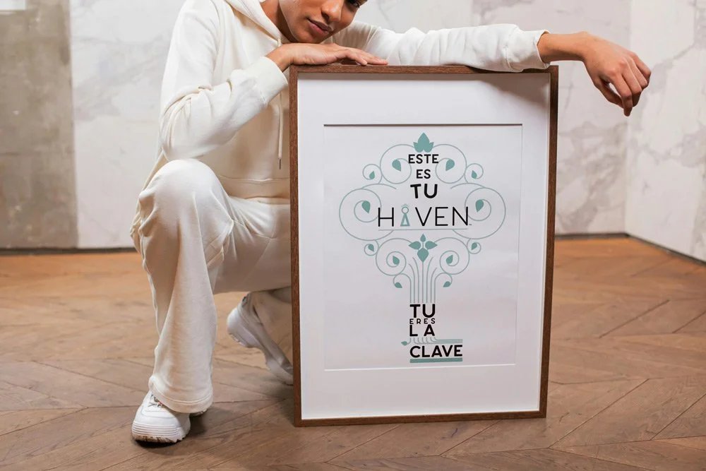Person wearing white tracksuit kneeling beside a whiteboard with Spanish text and decorative graphics.
