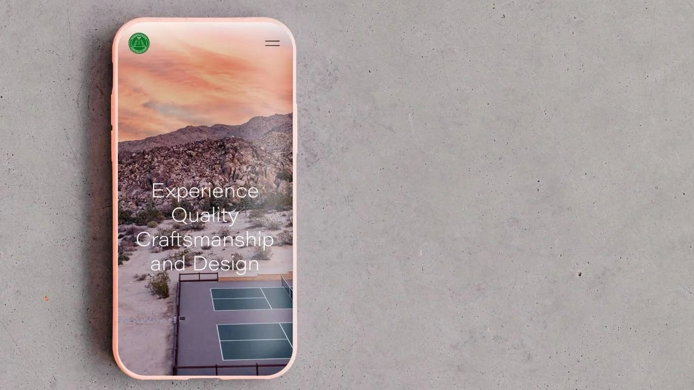 A smartphone with a sunset mountain landscape background displaying the words "Experience, Quality, Craftsmanship, and Design" with a tennis court in the foreground.