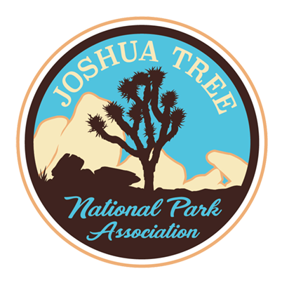 Logo of Joshua Tree National Park Association featuring a silhouette of a Joshua tree, mountains, and sky.