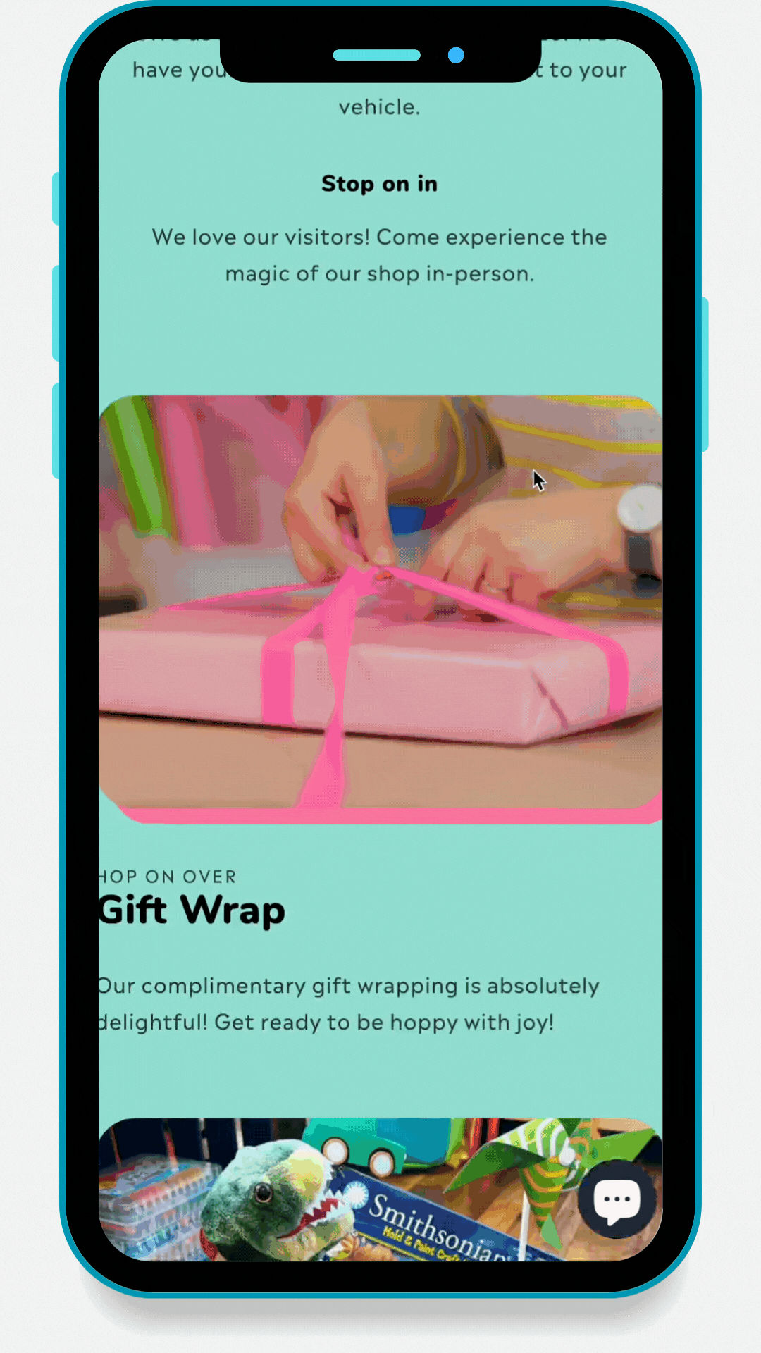 A mobile device displaying a webpage with a section about gift wrapping, showing a person tying a pink ribbon on a wrapped gift and a section about in-person shopping experience.