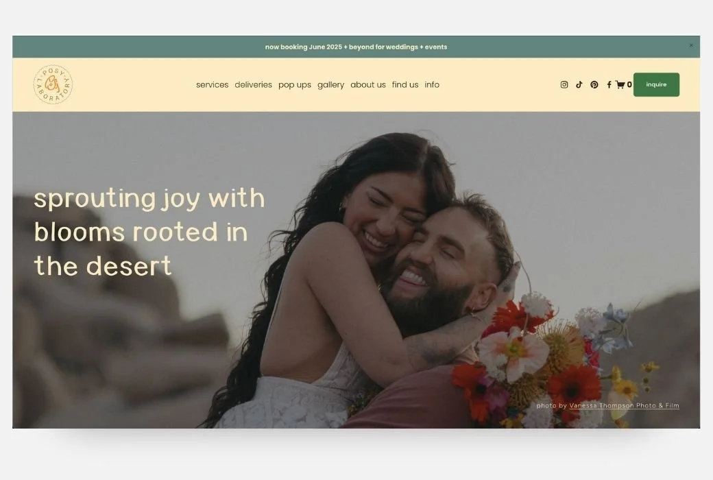 A woman and man embracing each other in a desert setting with flowers, smiling and happy.