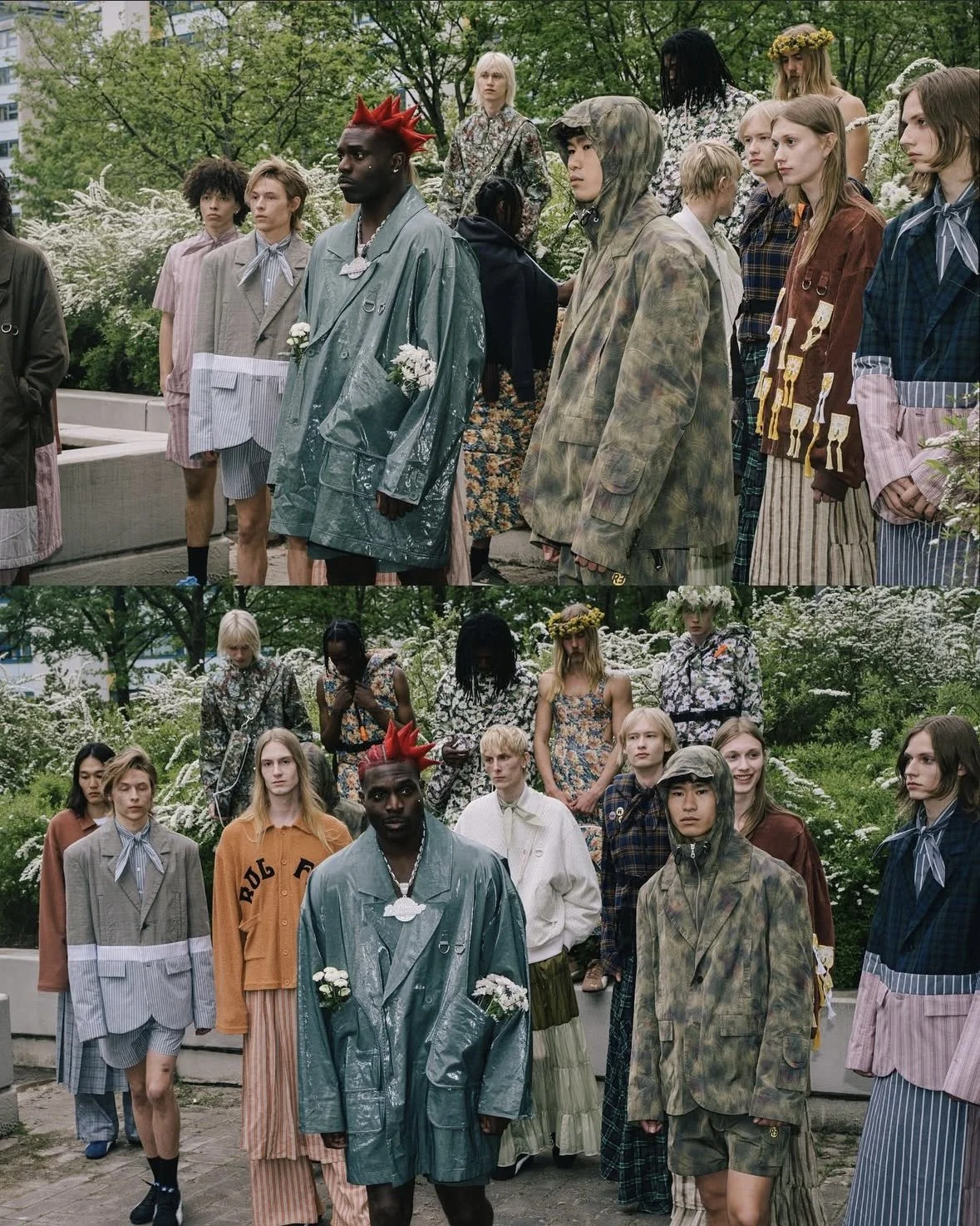 A group of diverse models in unconventional, floral, and plaid clothing poses outdoors in a lush, green garden with white flowers, for a fashion photoshoot. Turisti. roadman
