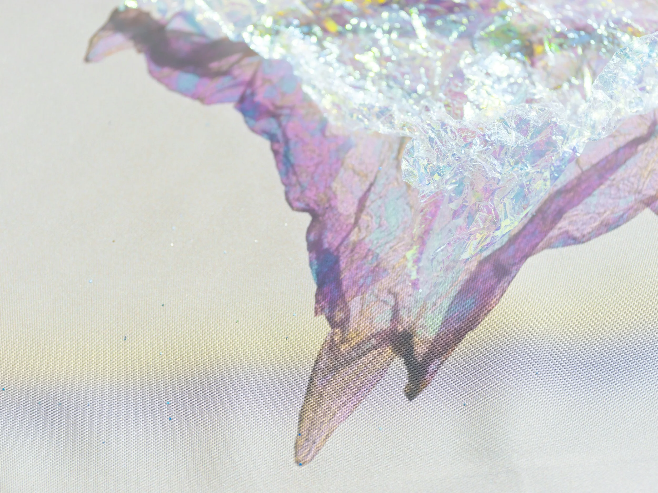 Close-up of a delicate, iridescent, holographic butterfly wing with pastel colors against a light background.