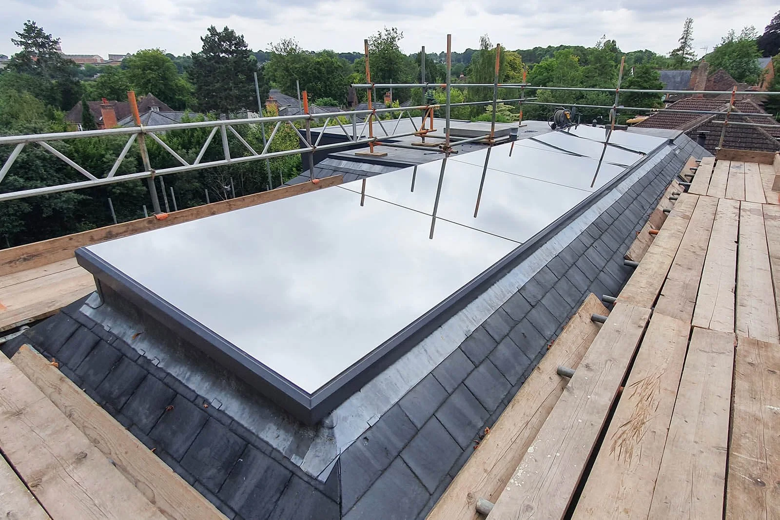 large sky light with sun control window film silver reflective installed to reduce solar heat gain in modern home