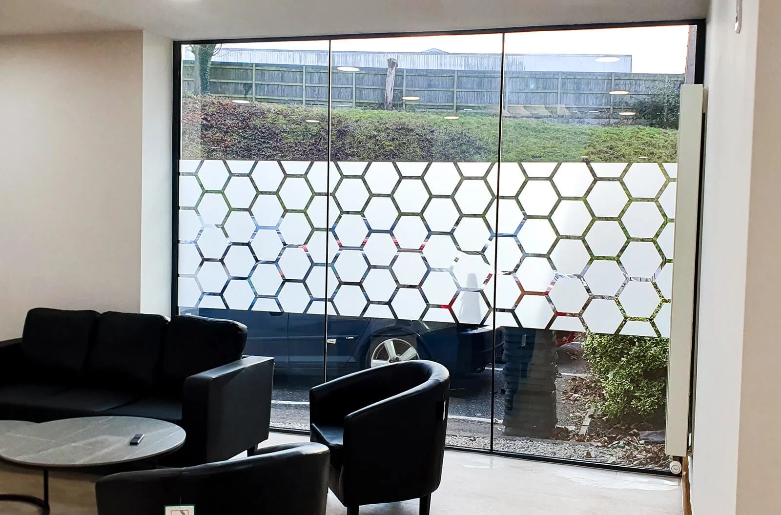 full length glass window with bespoke bee hive manifestation design